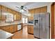 Bright kitchen with wood cabinets, stainless steel appliances, and laminate flooring at 95 Stephens Dr, Covington, GA 30016