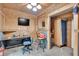 Office space in the barn featuring a desk, TV, chair, shelves and wood siding at 95 Stephens Dr, Covington, GA 30016