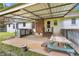 Covered patio with a ceiling fan, picnic table, sink, and view of the backyard at 95 Stephens Dr, Covington, GA 30016
