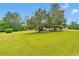 A green lawn with a hint of the home and storage building in the background at 95 Stephens Dr, Covington, GA 30016