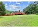 The expansive backyard features lush green lawn, great space for outdoor activities at 124 Crown Walk, Mcdonough, GA 30253
