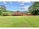 Expansive backyard featuring a deck and lush green lawn, perfect for outdoor enjoyment and entertaining at 124 Crown Walk, Mcdonough, GA 30253