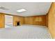 Spacious basement with wood paneling, and carpet at 124 Crown Walk, Mcdonough, GA 30253