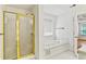 Bathroom featuring a shower with gold trim, a jacuzzi tub, and tile flooring at 124 Crown Walk, Mcdonough, GA 30253