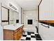 Bathroom with checkered tile flooring, updated vanity, and shower/tub combo at 124 Crown Walk, Mcdonough, GA 30253