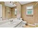 Bathroom features tiled shower, toilet, window and white vanity at 124 Crown Walk, Mcdonough, GA 30253