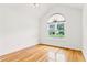 Sunlit bedroom features hardwood floors and large window with window shade at 124 Crown Walk, Mcdonough, GA 30253