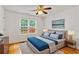 Staged bedroom featuring hardwood floors, ceiling fan and a large window at 124 Crown Walk, Mcdonough, GA 30253