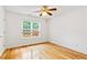Bright bedroom featuring hardwood floors and a large window at 124 Crown Walk, Mcdonough, GA 30253