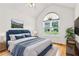 Staged bedroom featuring vaulted ceiling, hardwood floors and large window at 124 Crown Walk, Mcdonough, GA 30253