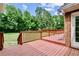Relax on the spacious wooden deck overlooking the wooded backyard, great for outdoor living at 124 Crown Walk, Mcdonough, GA 30253