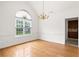 Bright and airy dining room with hardwood floors, a large window, and elegant chandelier at 124 Crown Walk, Mcdonough, GA 30253