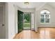 Bright foyer with hardwood floors and a view through the open door, complemented by ample natural light at 124 Crown Walk, Mcdonough, GA 30253