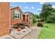 Close-up of the brick stairway leading to the front door, enhanced by landscaping and lush greenery at 124 Crown Walk, Mcdonough, GA 30253