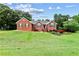 Charming brick home with green shutters and a beautifully landscaped front yard at 124 Crown Walk, Mcdonough, GA 30253