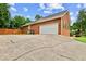 Image showcases a two-car garage attached to the brick home, offering parking and storage solutions at 124 Crown Walk, Mcdonough, GA 30253