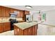 Bright kitchen features granite countertops, wood cabinets, stainless steel appliances and tile flooring at 124 Crown Walk, Mcdonough, GA 30253