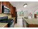 Well-lit kitchen boasts stainless steel appliances, granite countertops, and an inviting breakfast nook at 124 Crown Walk, Mcdonough, GA 30253