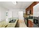 Spacious kitchen featuring stainless steel appliances, granite countertops, and ample cabinet space at 124 Crown Walk, Mcdonough, GA 30253