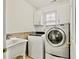 Laundry room with sink, cabinets, washing machine and dryer at 124 Crown Walk, Mcdonough, GA 30253