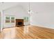 Bright living room with fireplace, hardwood floors, and large windows providing natural light at 124 Crown Walk, Mcdonough, GA 30253