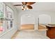 Inviting living room featuring hardwood floors, lots of natural light, and an arched doorway at 124 Crown Walk, Mcdonough, GA 30253