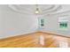 Serene main bedroom with tray ceiling, hardwood floors, and ample natural light at 124 Crown Walk, Mcdonough, GA 30253
