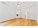 Unfurnished main bedroom with tray ceilings and hardwood floors, ready for you to make it your own at 124 Crown Walk, Mcdonough, GA 30253