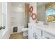 Bathroom with white vanity, patterned shower curtain, and a large mirror reflecting natural light at 209 Maycrest Path, Tucker, GA 30084