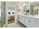 Bright bathroom with double sink vanity, framed mirrors and modern fixtures, connecting to the Primary bedroom at 209 Maycrest Path, Tucker, GA 30084
