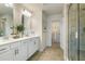 Bathroom featuring double sinks, white cabinets, walk-in shower, and walk-in closet at 209 Maycrest Path, Tucker, GA 30084