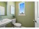 Stylish half-bathroom featuring a modern sink, toilet, and a serene wall color at 209 Maycrest Path, Tucker, GA 30084