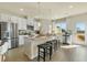 Bright, open kitchen with stainless steel appliances, a central island, and bar stool seating at 209 Maycrest Path, Tucker, GA 30084