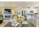 Open-concept living space with a fireplace and a modern kitchen with stainless steel appliances at 209 Maycrest Path, Tucker, GA 30084