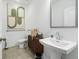 This powder room features a pedestal sink, decorative cabinet, modern mirror and attractive neutral decor at 209 Maycrest Path, Tucker, GA 30084