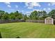 Expansive, fenced backyard with lush grass and a storage shed at 2624 Chase Rdg, Kennesaw, GA 30144