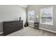 Bedroom featuring grey dresser, two windows providing natural light, neutral colored walls, and soft carpet at 2624 Chase Rdg, Kennesaw, GA 30144