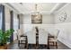 Elegant dining room with tray ceiling, chandelier, wainscoting, and wood floors at 2624 Chase Rdg, Kennesaw, GA 30144