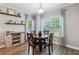 A charming dining room with a wooden table, four chairs, and natural light from the windows at 2624 Chase Rdg, Kennesaw, GA 30144