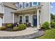 Charming front porch featuring a seating area and manicured landscaping at 2624 Chase Rdg, Kennesaw, GA 30144
