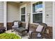 Inviting front porch with wicker chairs, stone accents, and a 'welcome' sign at 2624 Chase Rdg, Kennesaw, GA 30144