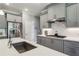 A close up on a modern kitchen with gray cabinets, stainless steel appliances, and white countertops at 2624 Chase Rdg, Kennesaw, GA 30144