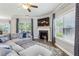 Comfortable living room with a fireplace, large windows, and a cozy gray sofa at 2624 Chase Rdg, Kennesaw, GA 30144