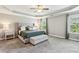 Spacious main bedroom featuring a tray ceiling, carpet flooring, and bright natural light at 2624 Chase Rdg, Kennesaw, GA 30144