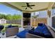 Outdoor patio features plush wicker furniture, a stone fireplace, and a view of the fenced backyard at 2624 Chase Rdg, Kennesaw, GA 30144