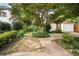 Landscaped backyard with a brick paver walkway and detached garage at 1095 Saint Charles Ne Pl, Atlanta, GA 30306