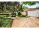 Landscaped backyard with a driveway and detached garage at 1095 Saint Charles Ne Pl, Atlanta, GA 30306