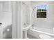 Bright bathroom featuring white fixtures, a pedestal sink, and a shower over tub at 1095 Saint Charles Ne Pl, Atlanta, GA 30306