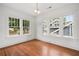 Bright bedroom with hardwood floors and three large windows at 1095 Saint Charles Ne Pl, Atlanta, GA 30306