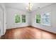 Inviting bedroom boasting hardwood floors, a chandelier, and multiple windows at 1095 Saint Charles Ne Pl, Atlanta, GA 30306